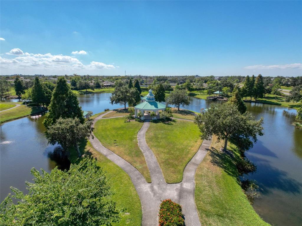 335 Cockle Shell Loop Apollo Beach, FL 33572 - Photo 76 of 90 an aerial view of a house with a garden and lake view