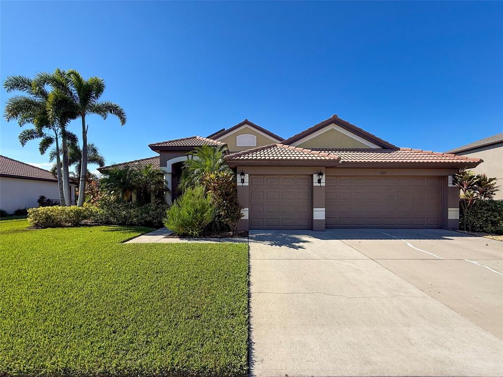 335 Cockle Shell Loop Apollo Beach, FL 33572 - Photo 90 of 90 a front view of a house with garden