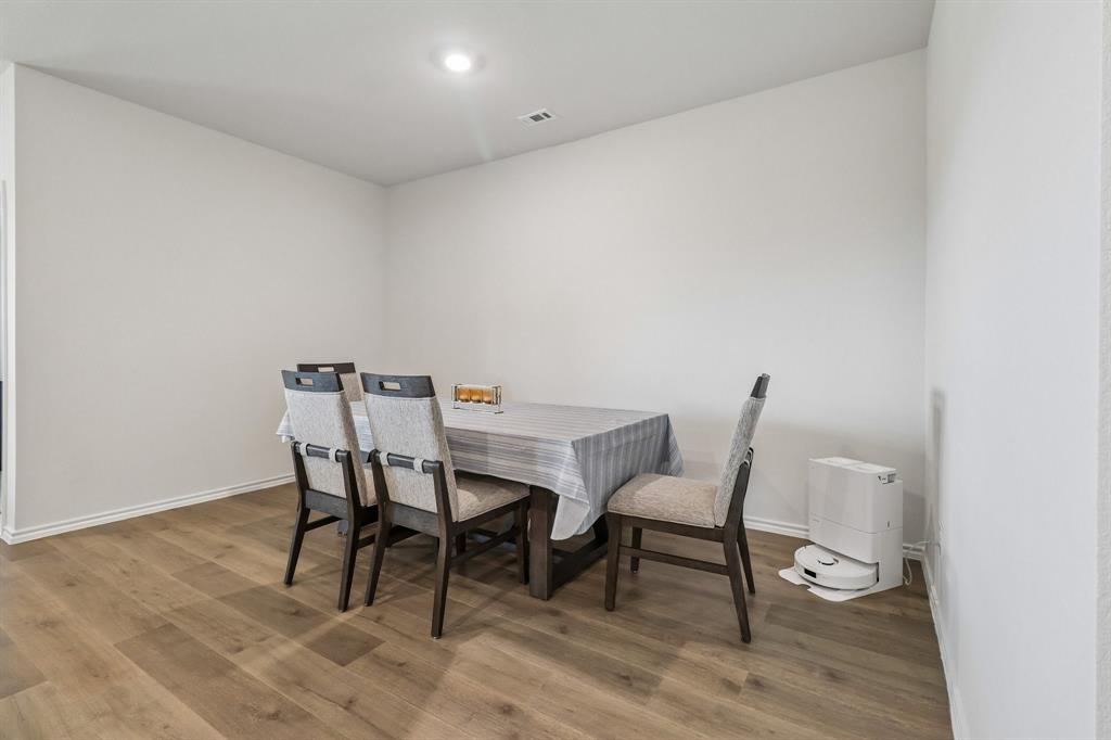 1453 Millstead Rill Road Caddo Mills, TX 75135 - Photo 12 of 40 Dining area featuring wood-finish flooring, white baseboards, and a recessed ceiling light