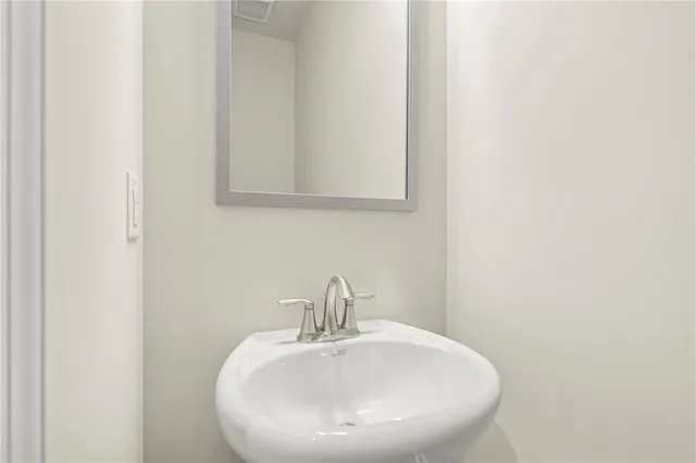 a bathroom with a sink and mirror