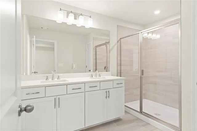 a bathroom with double sink and a mirror