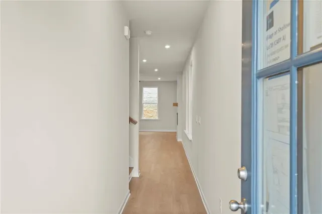 a view of a hallway with wooden floor