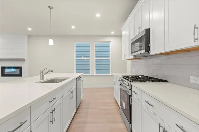 a kitchen with a sink stove and cabinets