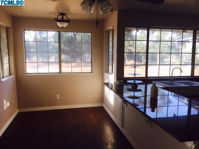 355 South Cornucopia Road Exeter, CA 93221 - Photo 5 of 26 a view of a kitchen with stainless steel appliances wooden floor and a large window