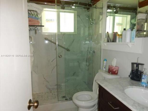 29 Bonefish Avenue Key Largo, FL 33037 - Photo 11 of 31 a bathroom with a granite countertop sink a toilet and shower