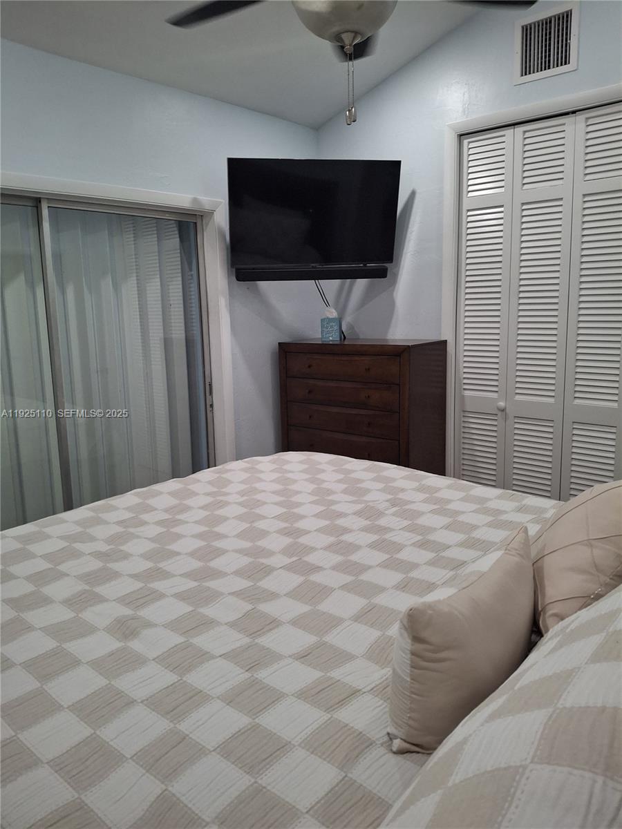 29 Bonefish Avenue Key Largo, FL 33037 - Photo 26 of 31 a bedroom with a bed and a flat screen tv