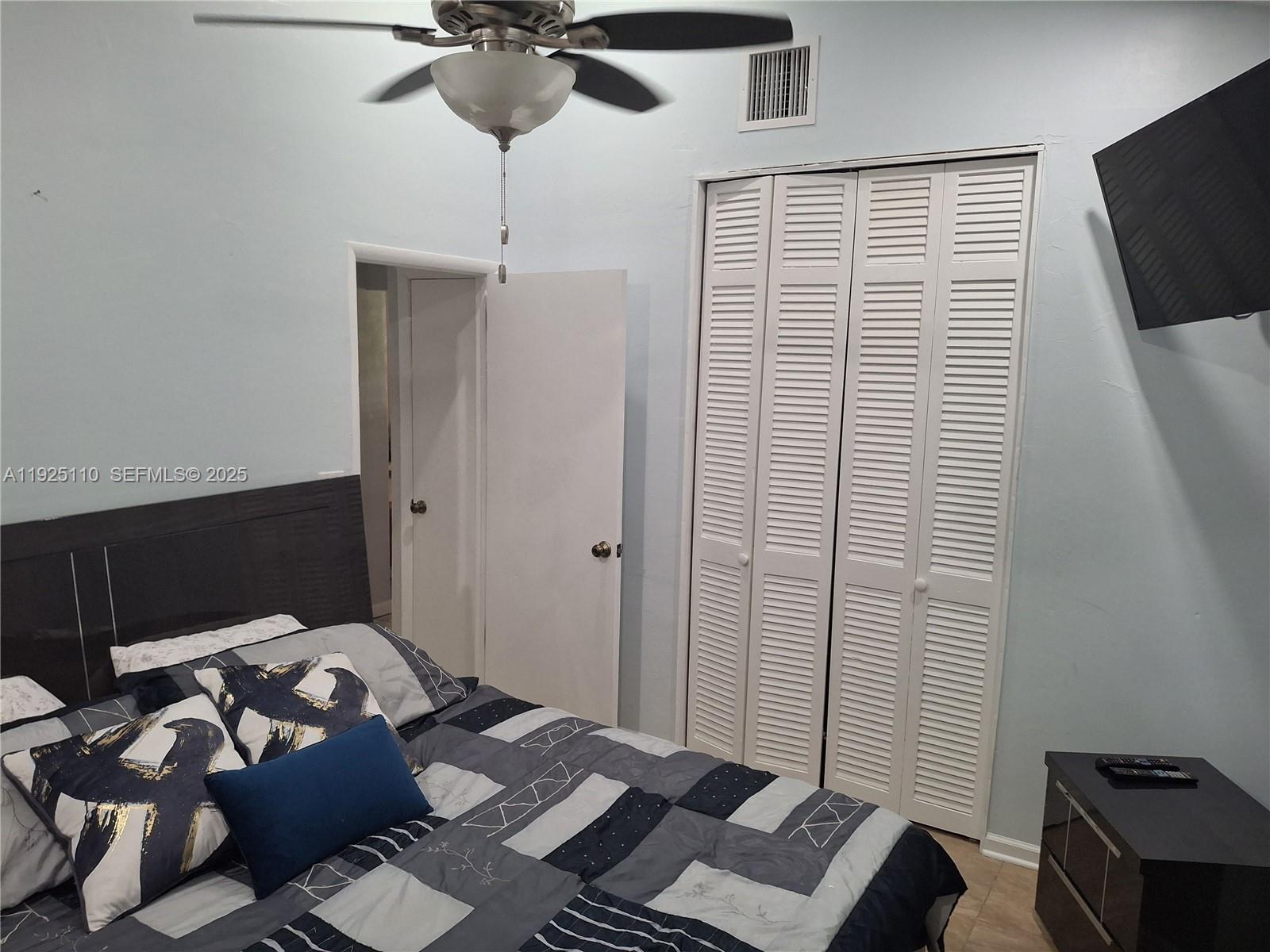 29 Bonefish Avenue Key Largo, FL 33037 - Photo 29 of 31 a bedroom with a bed and wooden floor