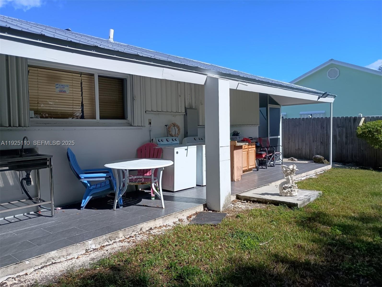 29 Bonefish Avenue Key Largo, FL 33037 - Photo 8 of 31 a backyard of a house with table and chairs