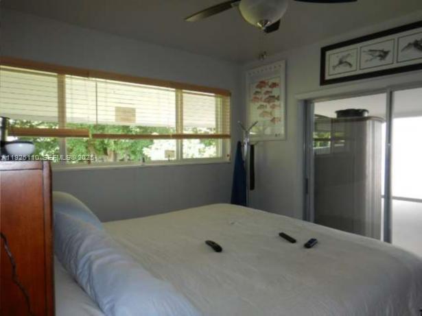 29 Bonefish Avenue Key Largo, FL 33037 - Photo 10 of 31 a bed sitting in a bedroom next to a window