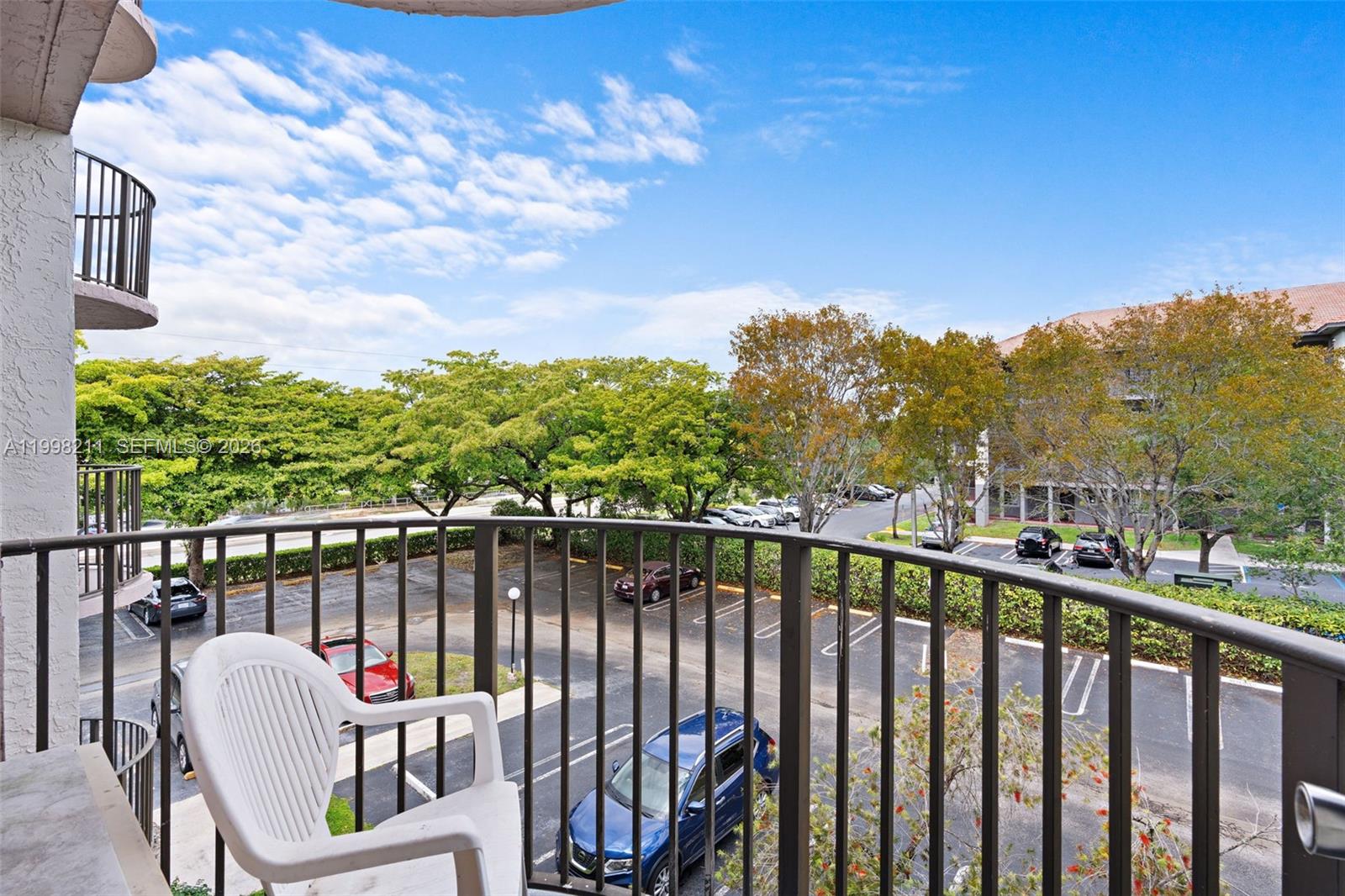 2771 Riverside Drive, Unit 316A Coral Springs, FL 33065 - Photo 18 of 20 a view of a balcony with wooden floor & fence