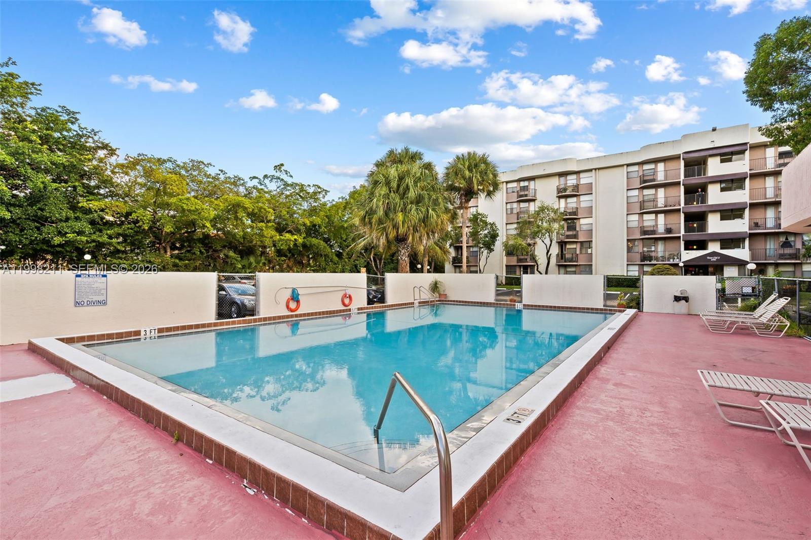2771 Riverside Drive, Unit 316A Coral Springs, FL 33065 - Photo 19 of 20 a view of a swimming pool with a patio