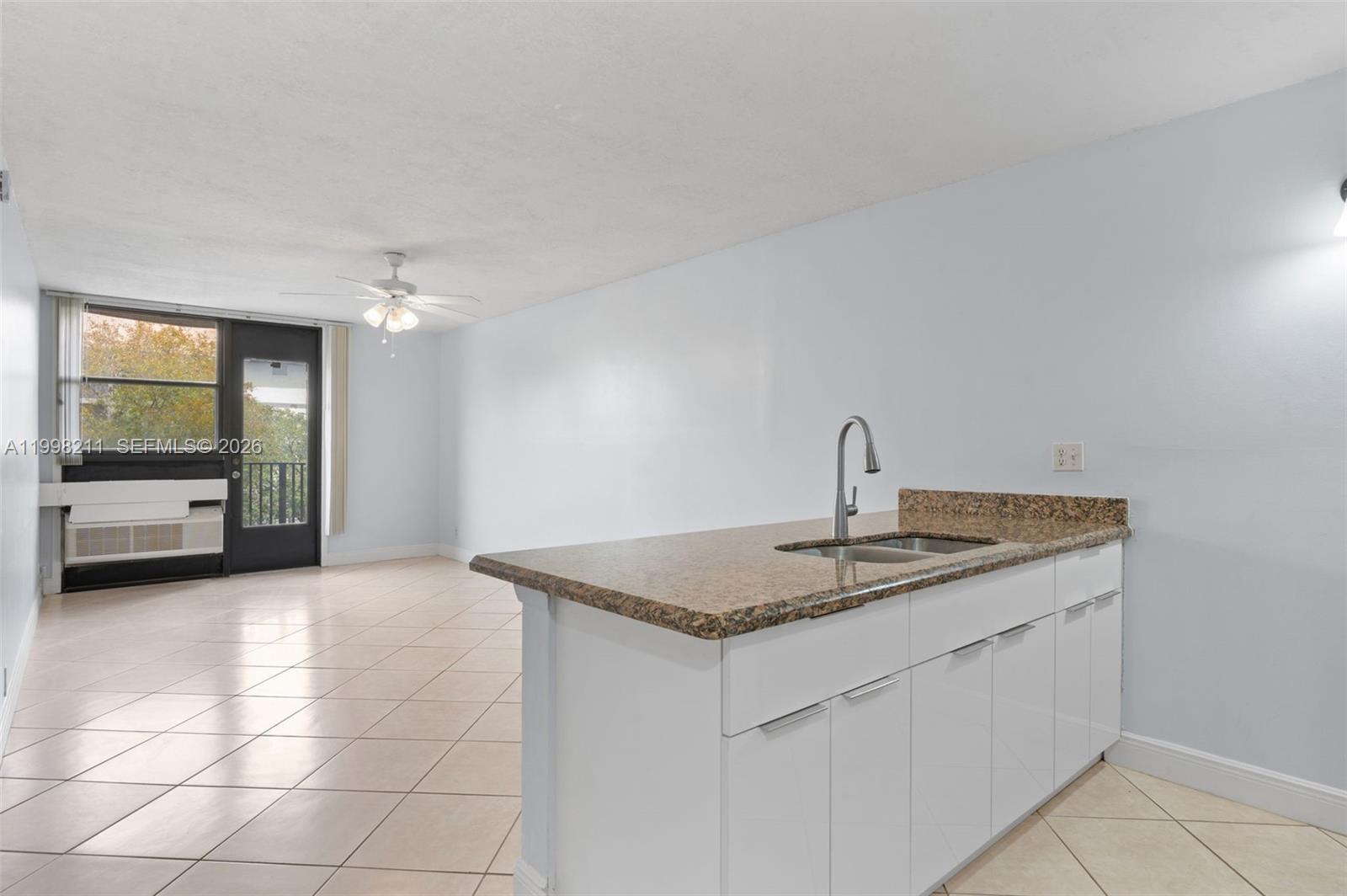 2771 Riverside Drive, Unit 316A Coral Springs, FL 33065 - Photo 3 of 20 a kitchen with a sink and a mirror