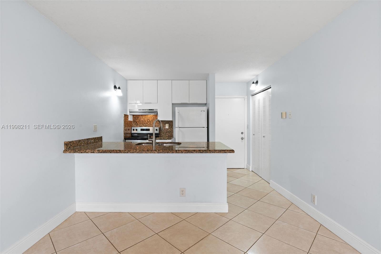 2771 Riverside Drive, Unit 316A Coral Springs, FL 33065 - Photo 6 of 20 a kitchen with stainless steel appliances a refrigerator and a stove