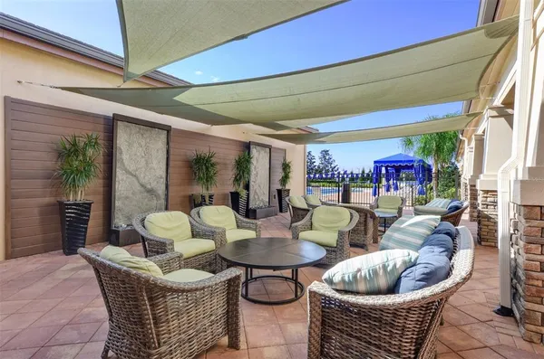 a view of outdoor dining space with a table and chairs