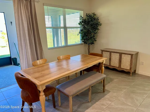 a dining room with furniture and window