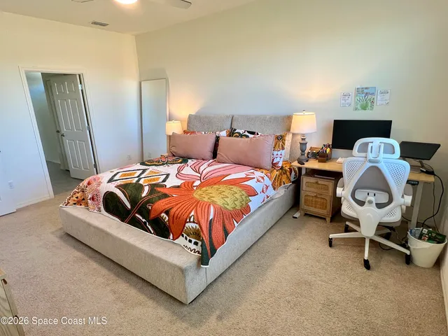 a bed sitting in a bedroom next to a window