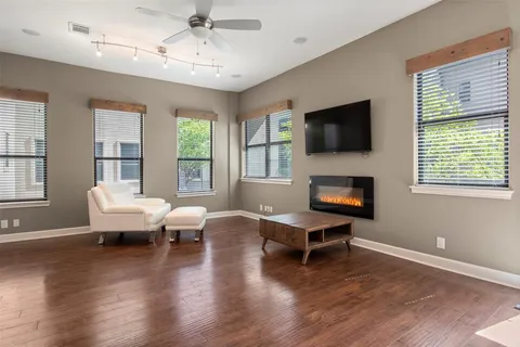 a living room with fireplace furniture and a flat screen tv