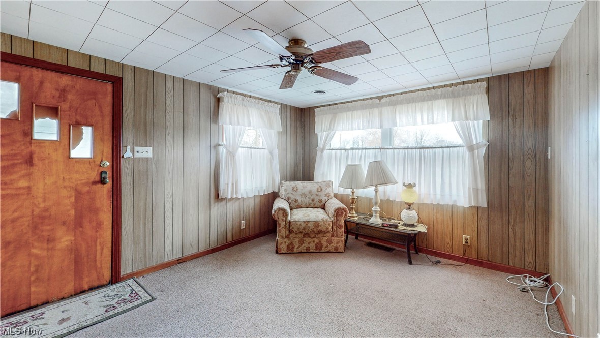 466 Pine Lake Road Sebring, OH 44672 - Photo 24 of 30 Unfurnished room with light carpet, wood walls, and ceiling fan