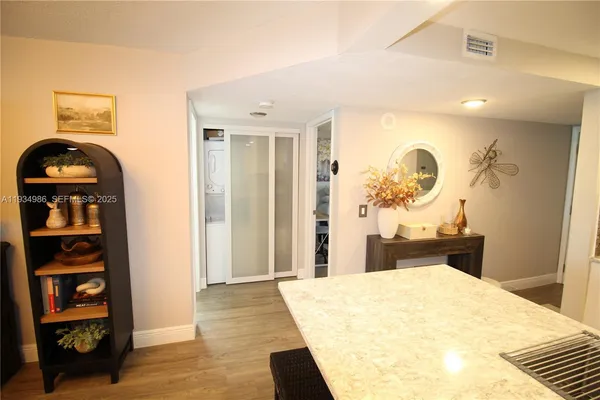 a bedroom with a large bed and a potted plant