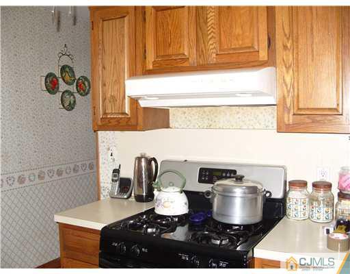 15 Harvard Road Old Bridge, NJ 08859 - Photo 2 of 20 a kitchen with a stove and a cabinet