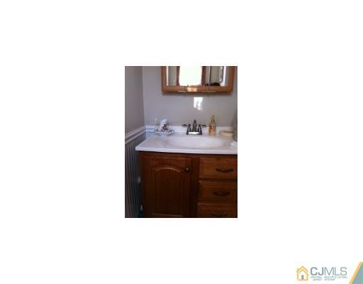 15 Harvard Road Old Bridge, NJ 08859 - Photo 18 of 20 a kitchen with a sink and a mirror