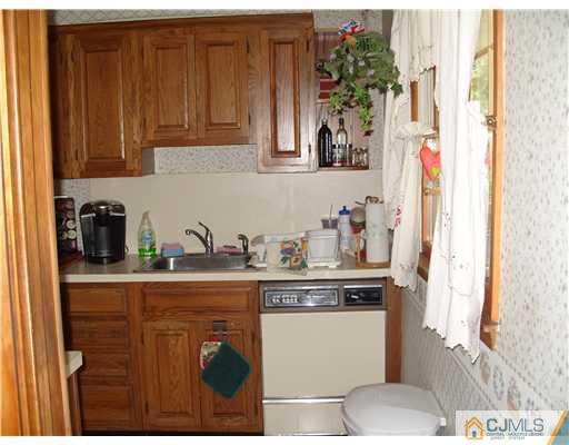 15 Harvard Road Old Bridge, NJ 08859 - Photo 3 of 20 a kitchen with stainless steel appliances granite countertop a refrigerator and a stove