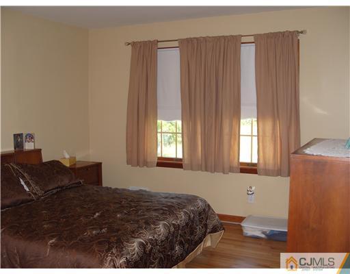 15 Harvard Road Old Bridge, NJ 08859 - Photo 4 of 20 a bedroom with a bed and a window
