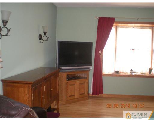 15 Harvard Road Old Bridge, NJ 08859 - Photo 9 of 20 a living room with a flat screen tv and a fireplace