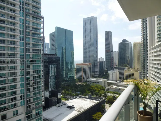 a view of balcony with a couple of cars parked in front of it