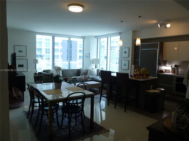 a view of a dining room with furniture and window
