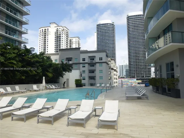 a view of a patio with couches table and chairs and potted plants