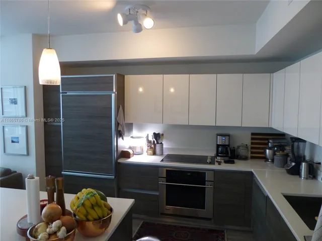 a kitchen with a sink cabinets and appliances