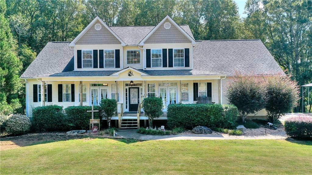 4694 Wayne Poultry Road Jefferson, GA 30549 - Photo 1 of 1 a front view of a house with a yard table and chairs