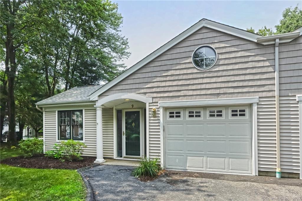 9 Red Cedar Road, Unit 9 Orange, CT 06477 - Photo 1 of 1 a front view of a house with a yard and garage