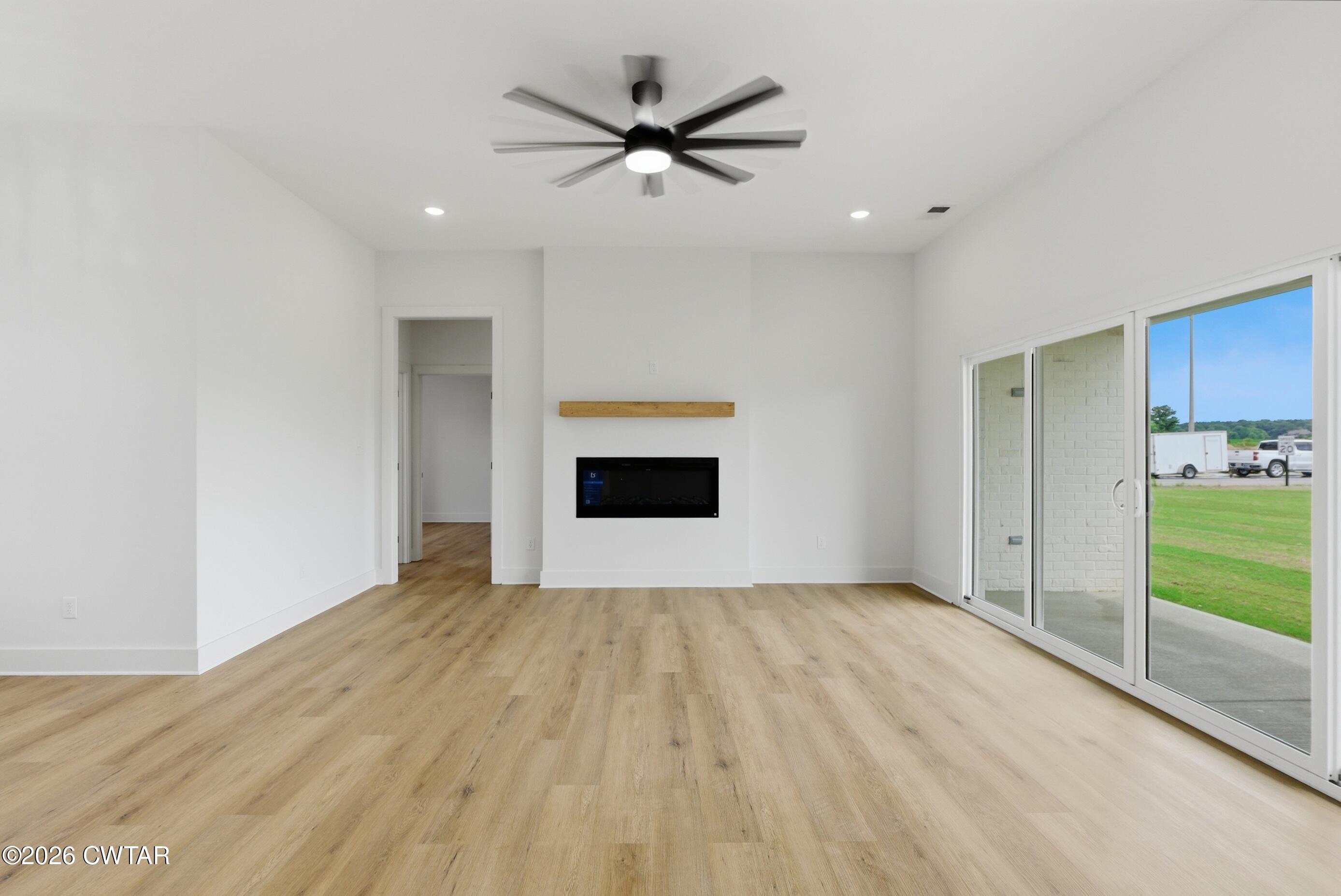 179 Daybreak Loop Medina, TN 38355 - Photo 3 of 32 a view of room with wooden floor and a ceiling fan