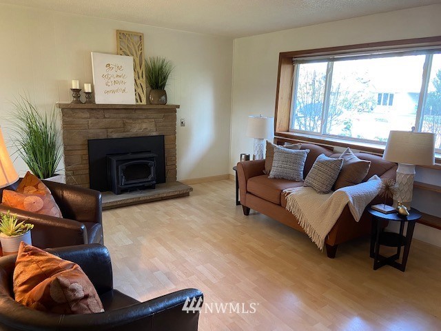859 Queen Avenue Northeast Renton, WA 98056 - Photo 2 of 24 a living room with furniture and a fireplace