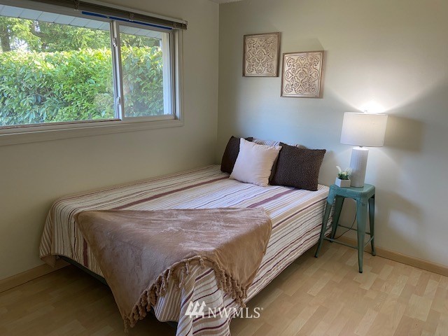 859 Queen Avenue Northeast Renton, WA 98056 - Photo 8 of 24 a bedroom with a bed and a window