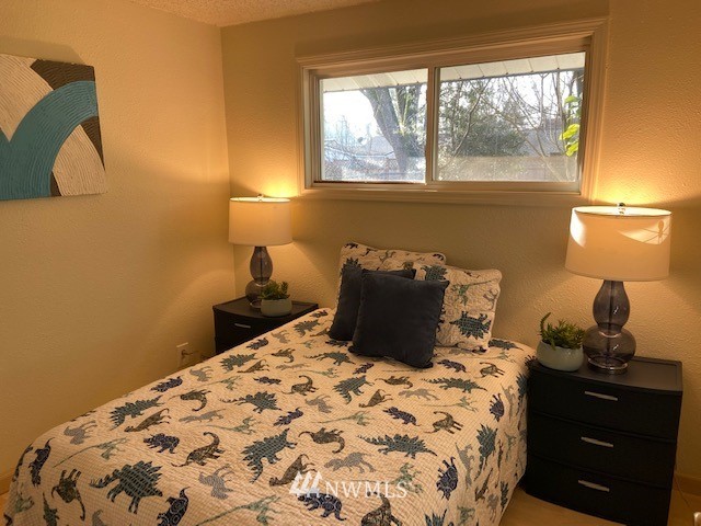 859 Queen Avenue Northeast Renton, WA 98056 - Photo 9 of 24 a bed sitting in a bedroom next to a window