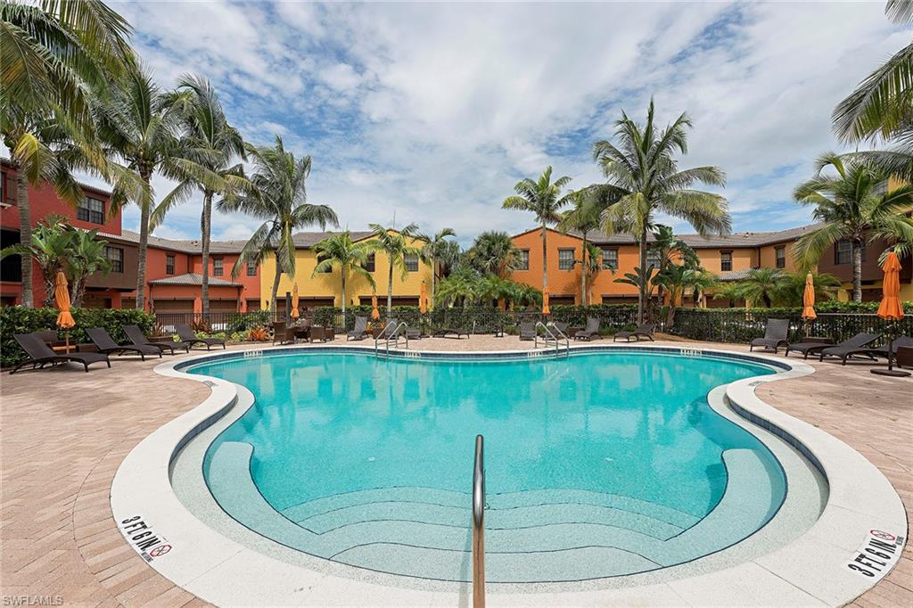 9102 Capistrano Street South, Unit 723 Naples, FL 34113 - Photo 2 of 12 a view of a swimming pool with outdoor seating