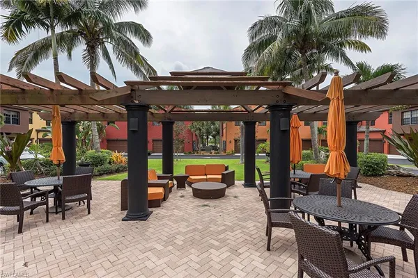 a backyard of a house with barbeque oven table and chairs