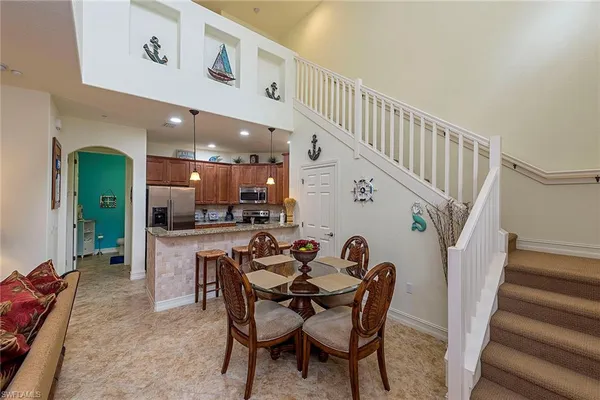 a dining room with furniture and wooden floor