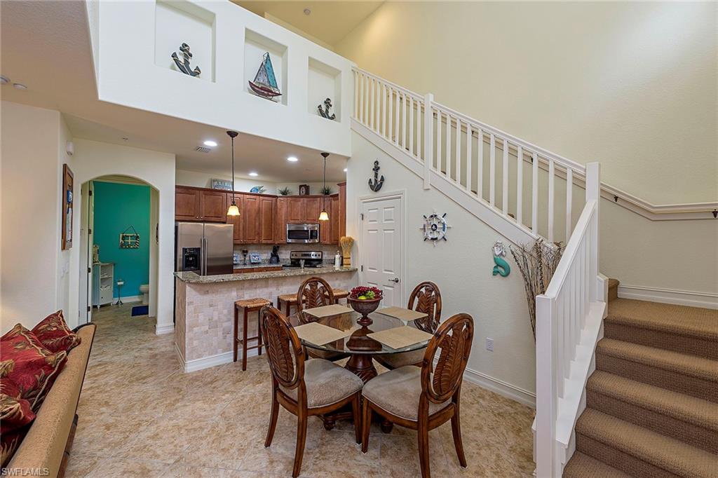 9102 Capistrano Street South, Unit 723 Naples, FL 34113 - Photo 5 of 12 a dining room with furniture and wooden floor