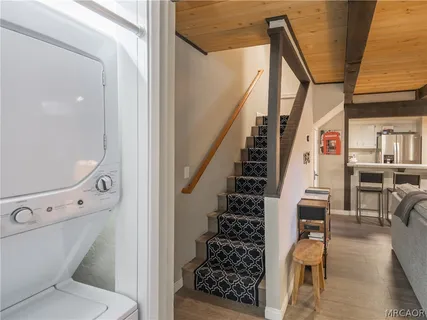 a bedroom with a bed a bookshelf and a window