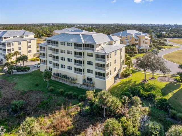 a living room with furniture a potted plant and a large window