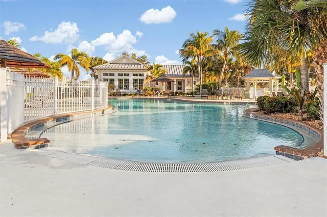 a view of a swimming pool with outdoor seating
