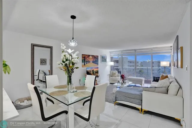 a living room with furniture a chandelier and a table