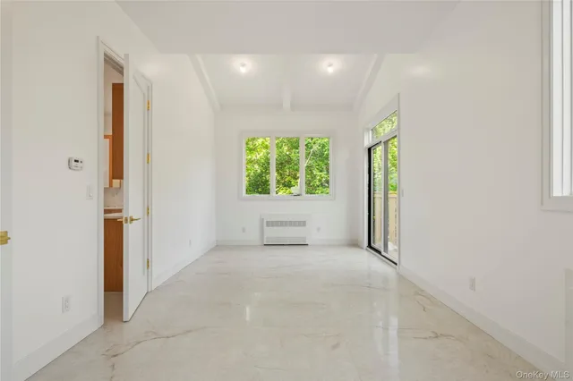 an empty room with windows and painted walls