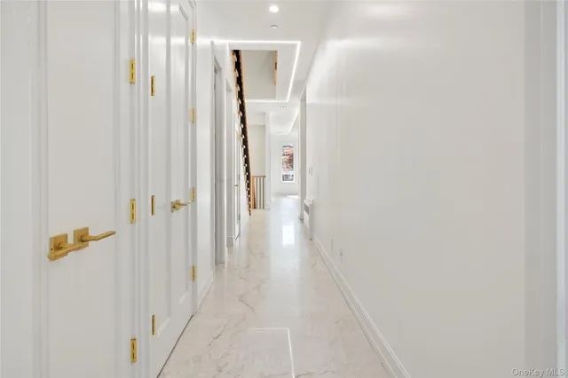 a view of staircase with railing and white walls