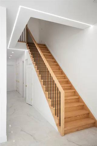 a view of a hallway with wooden floor and closet