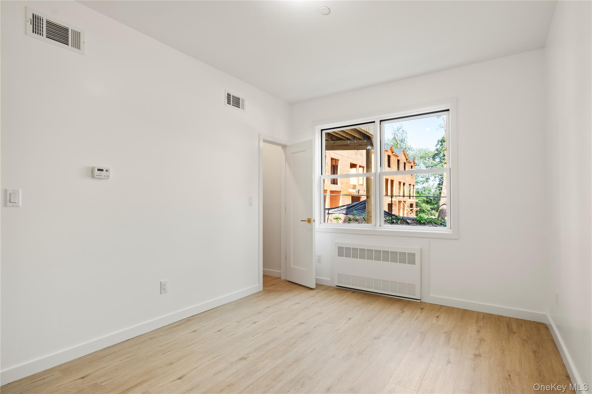 130 Union Road, Unit 201 Spring Valley, NY 10977 - Photo 41 of 47 an empty room with wooden floor and windows